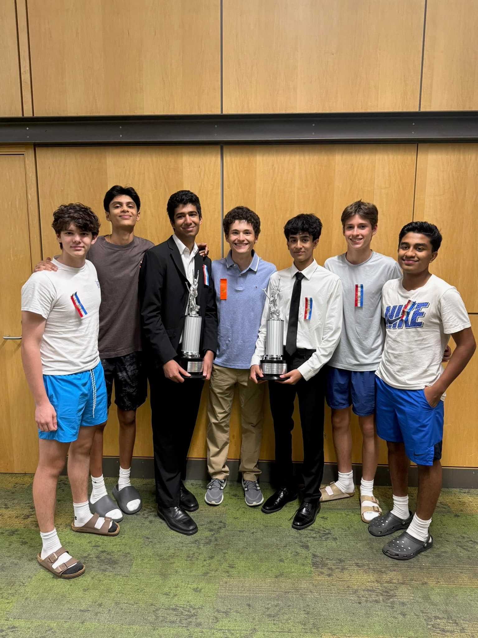 Debate team with trophies